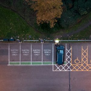 Bird's eye view of a parking lot with "Electric Vehicle Only" spots