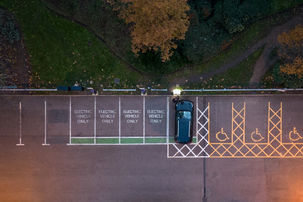 Bird's eye view of a parking lot with "Electric Vehicle Only" spots