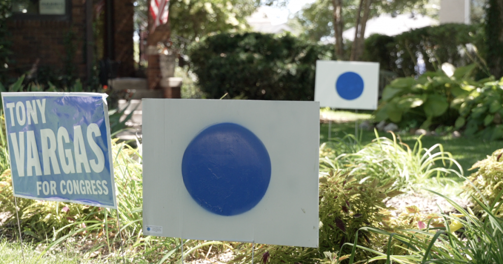 Yard sign with blue dot against white background